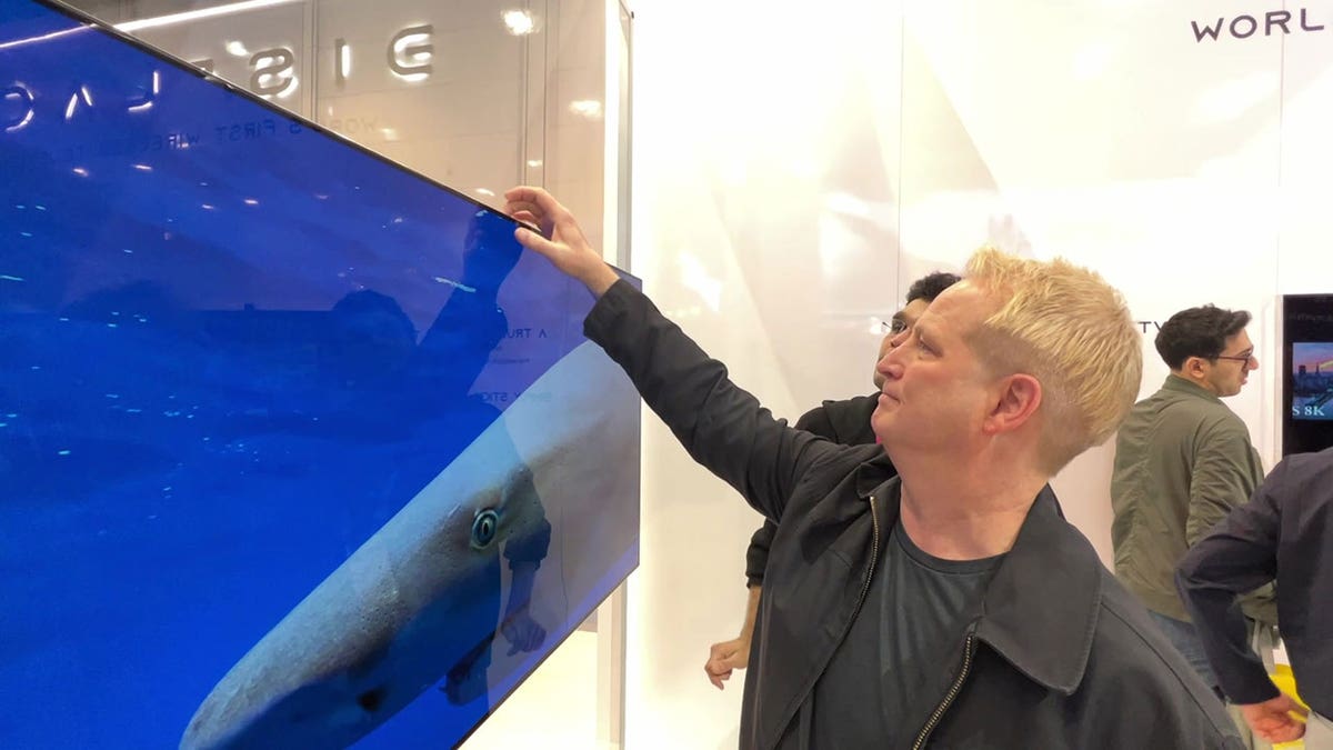 Kurt interacts with large flatscreen TV