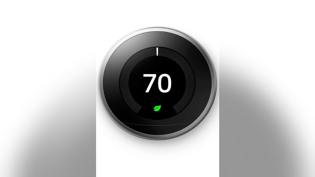 A black Google nest thermostat.