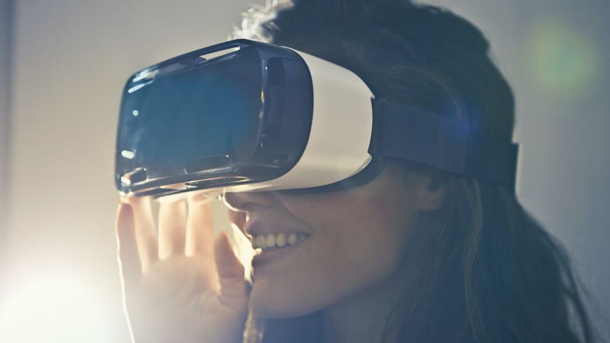 Woman wearing a VR headset while smiling