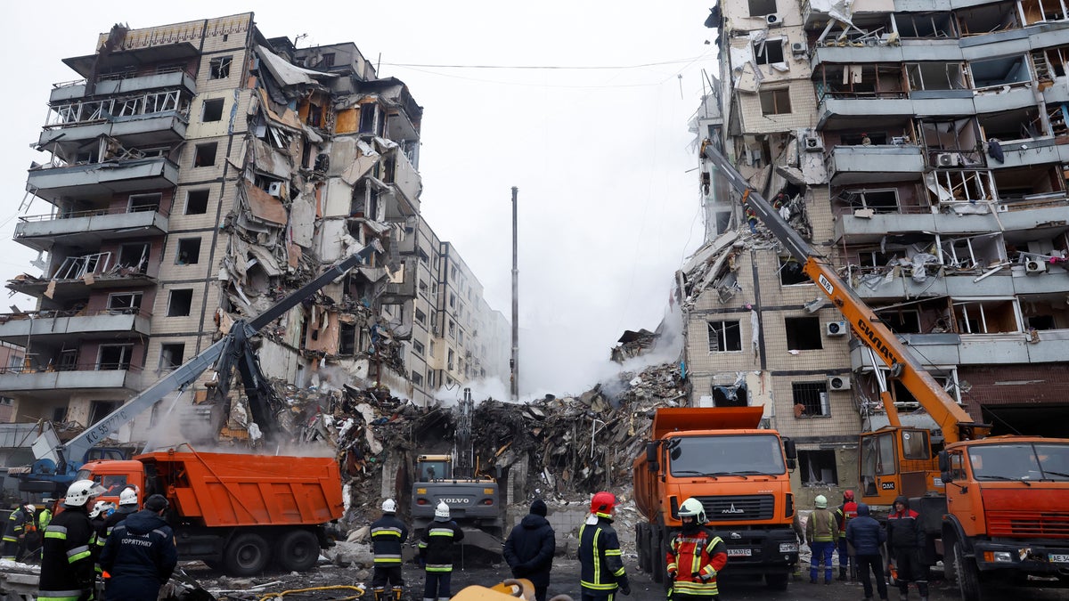 Emergency personnel work at the site where an apartment block was heavily damaged by a Russian missile strike in Dnipro, Ukraine, on Jan. 15, 2023. (Reuters/Clodagh Kilcoyne)