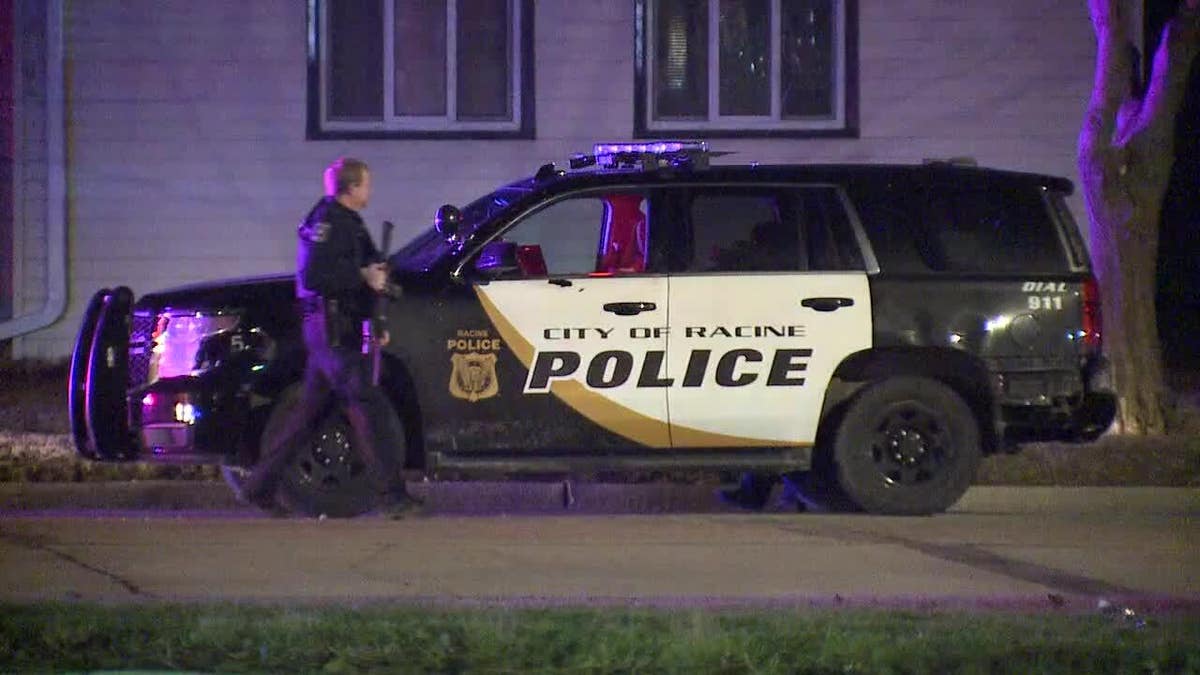 police officer walking past cruiser