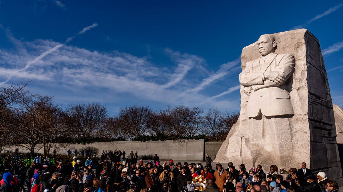 People celebrate in front of MLK statue