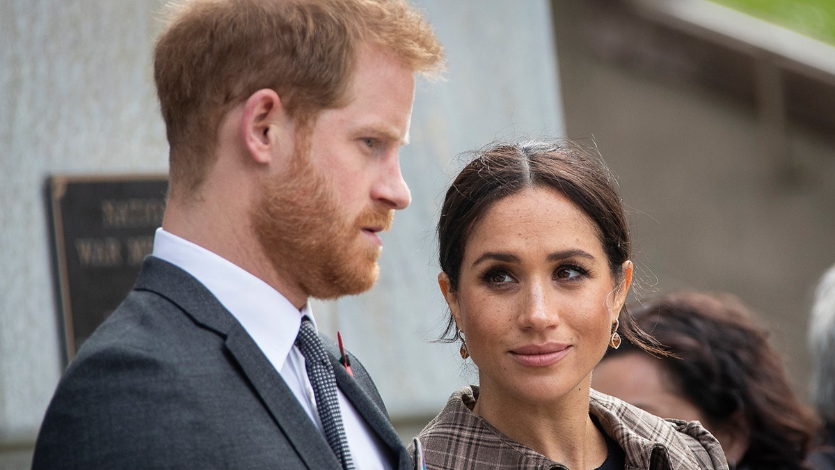 Prince Harry and Meghan Markle looking serious during a royal engagement