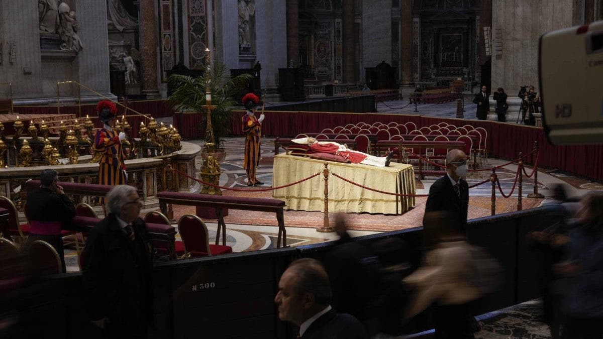 People view the body of late Pope Benedict