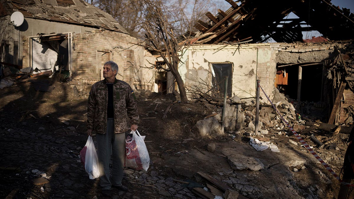 Anatolii Kaharlytskyi, 73, stands near his house, heavily damaged after a Russian attack in Kyiv, Ukraine, Monday, Jan. 2, 2023. Kaharlytskyi was injured, and his daughter-in-law Iryna died in the attack on Dec. 31, 2022.