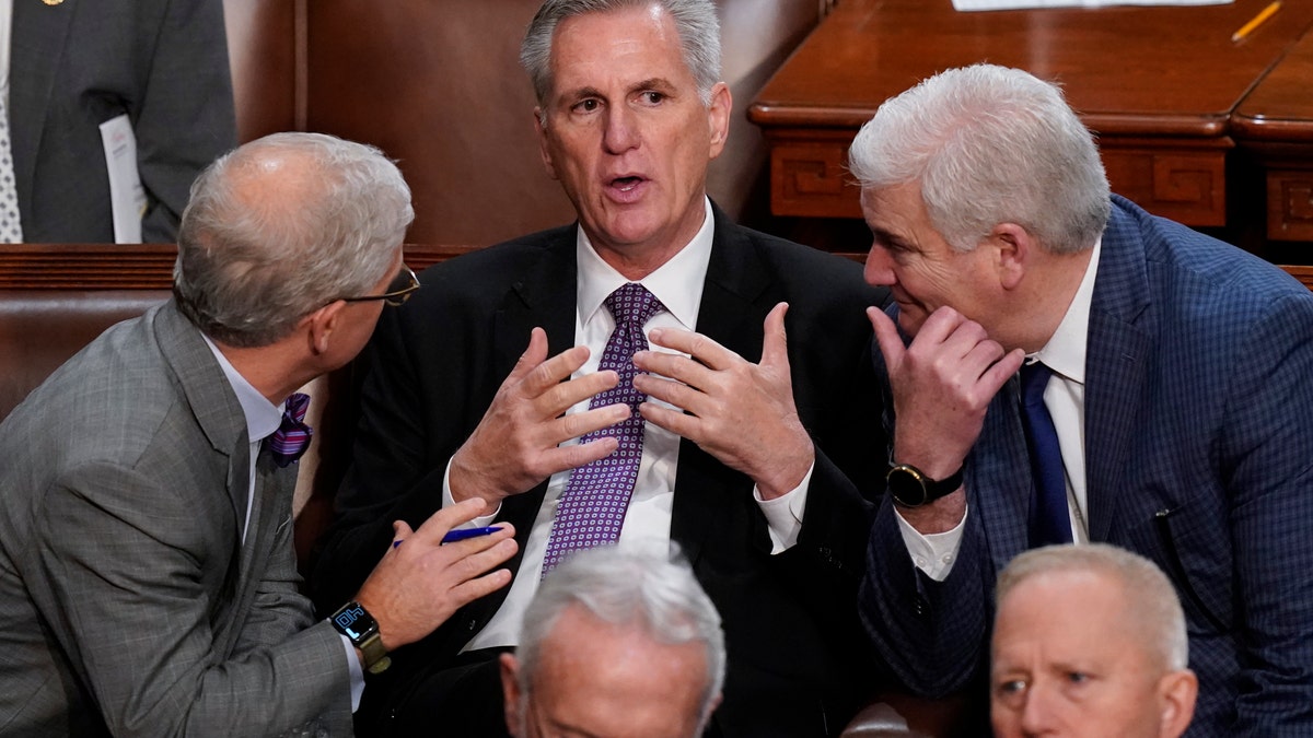 Rep. Patrick McHenry, left, and Rep. Tom Emmer, right, speak with Rep. Kevin McCarthy