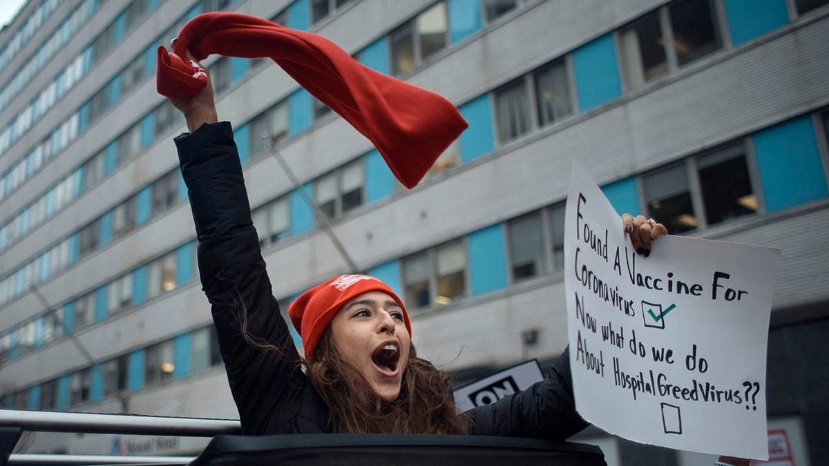 nurse on strike waives red flag from car skyroof