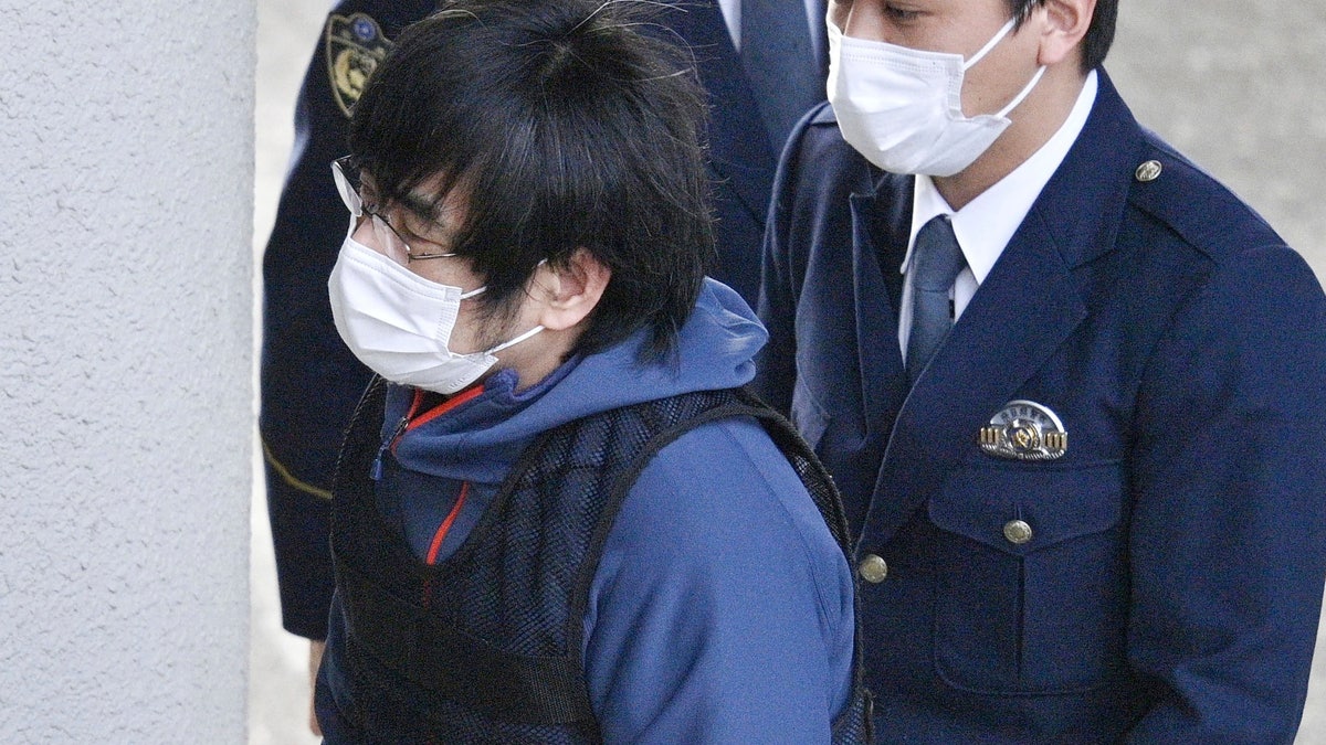 Shinzo Abe assassination suspect walking into a police station in Japan