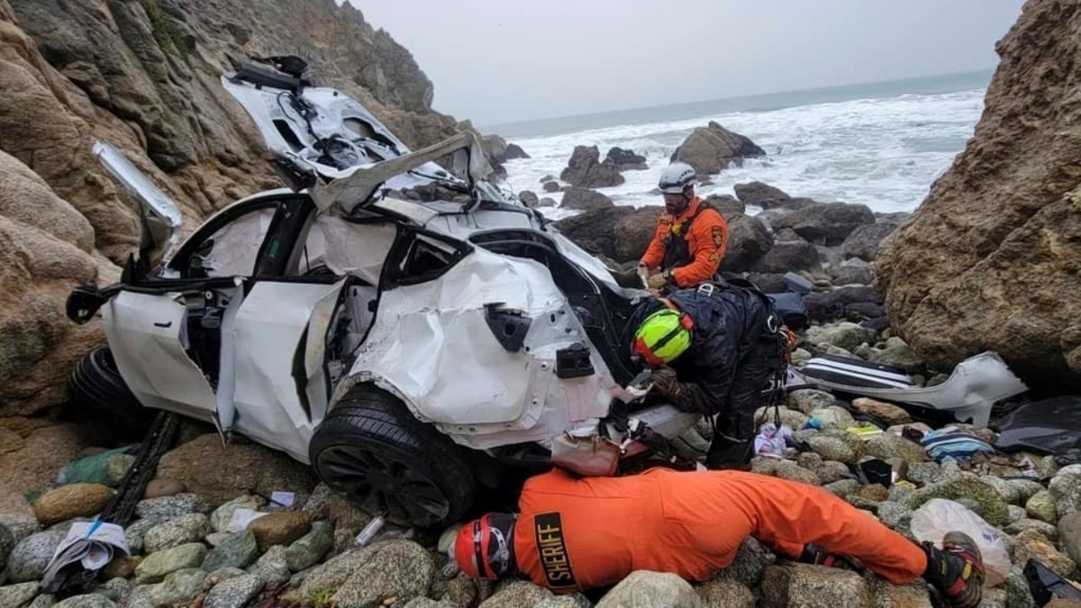 In this photo provided by the San Mateo County Sheriff's Office, emergency personnel respond to a vehicle over the side of Highway 1 on Jan. 1, 2023, in San Mateo County, Calif.