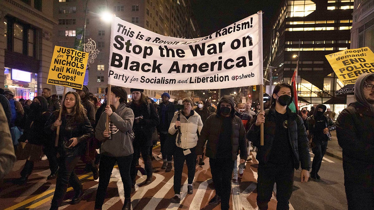 Tyre Nichols NYC protesters march with "Stop the War on Black America " sign