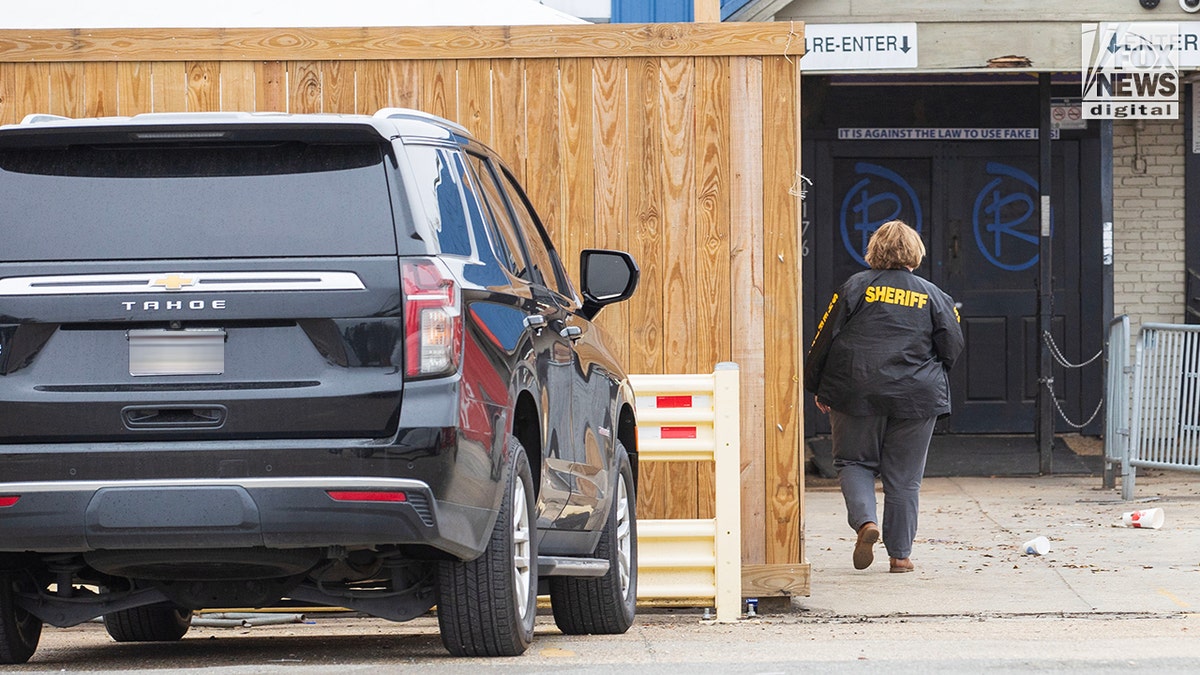 A woman is seen standing outside a local bar.