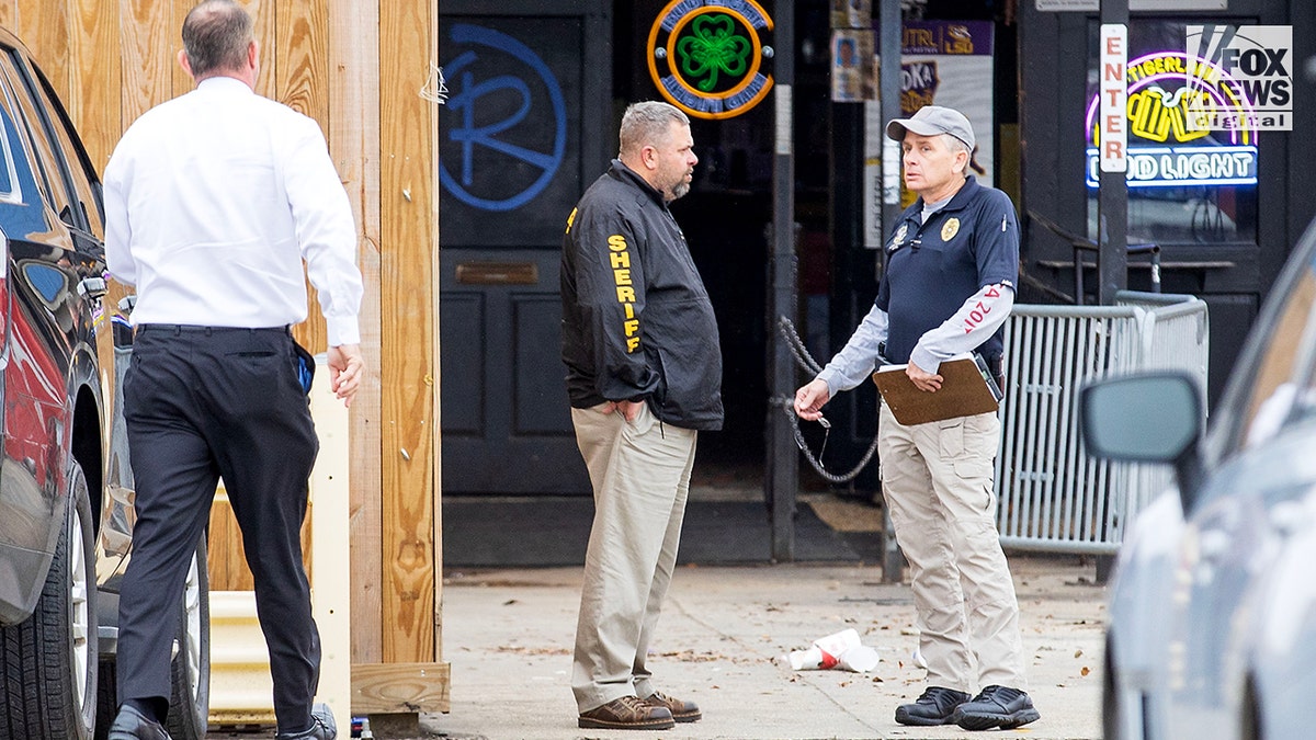 An exterior view investigators standing outside a local bar.