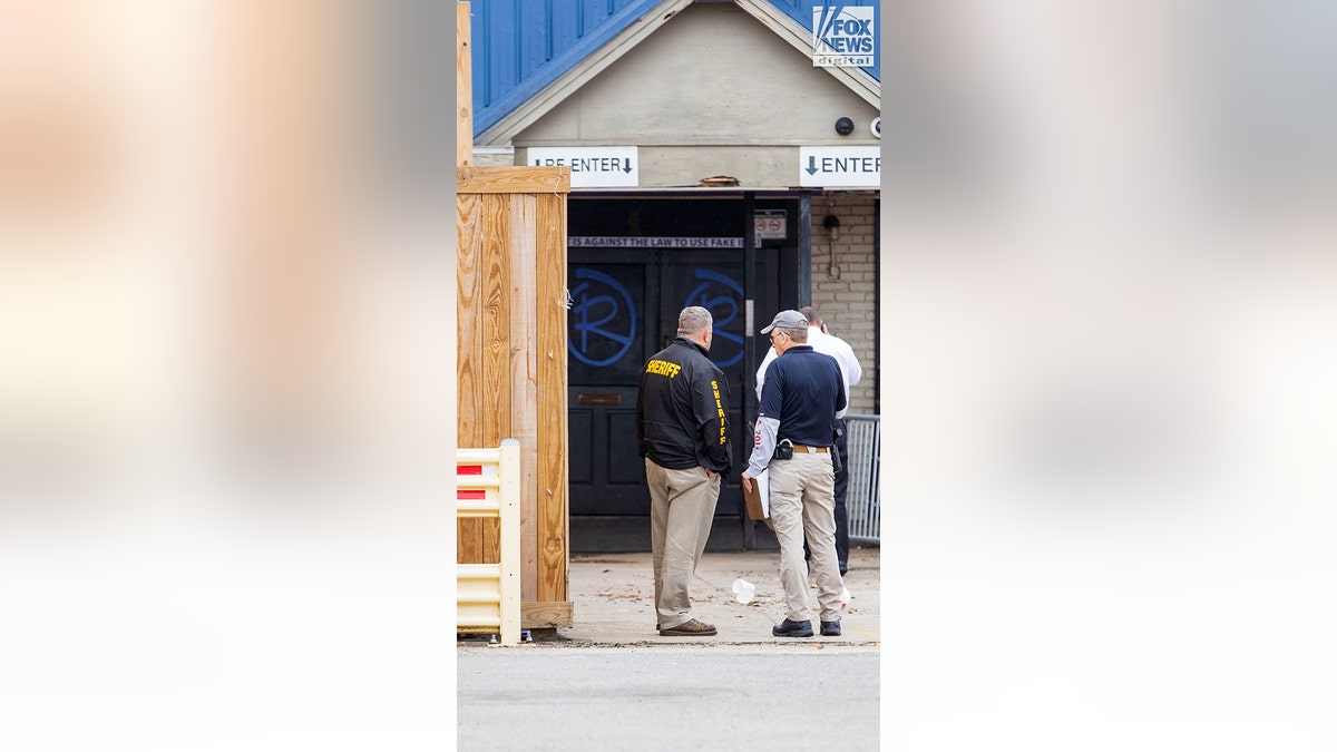 Three men seen standing outside a local bar.