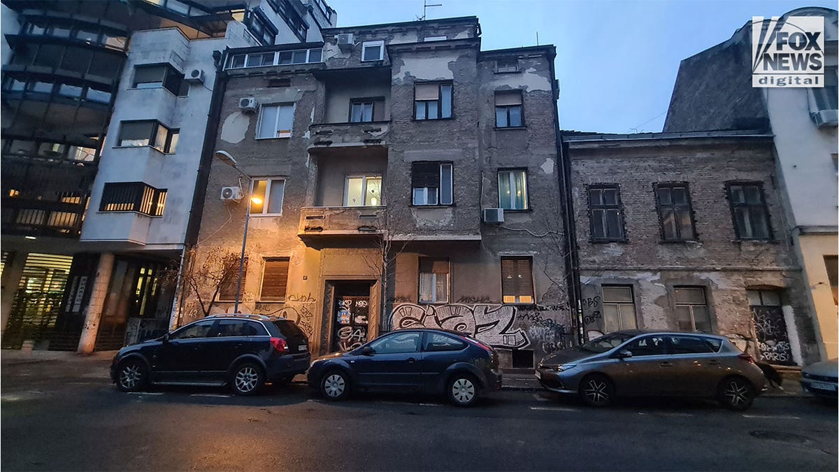 Apartment building in an urban setting with graffiti on the exterior walls