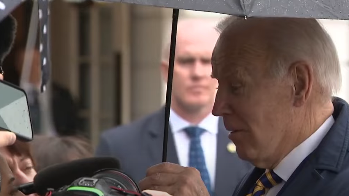President Biden holding umbrella
