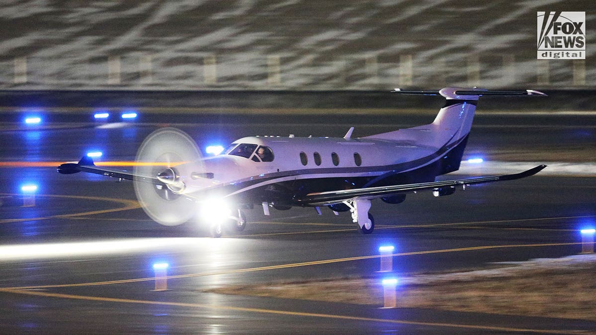 Aircraft with spinning propeller taxis on the tarmac