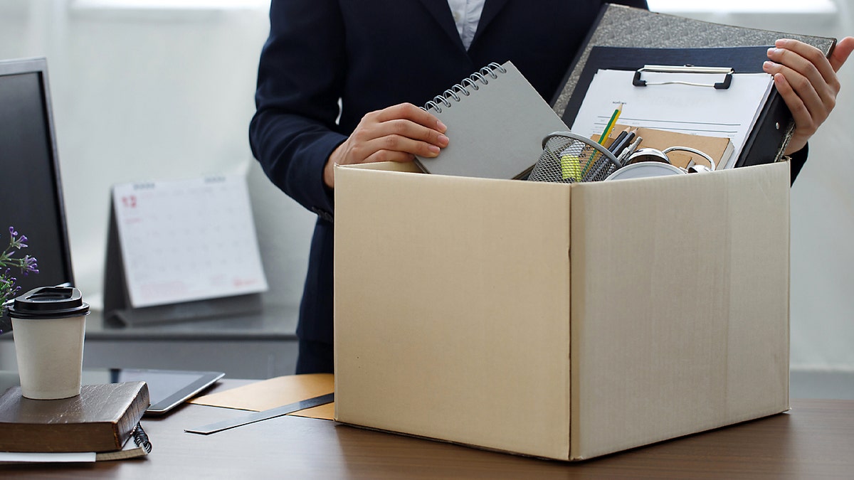 A box being packed up by an office worker after being laid off.