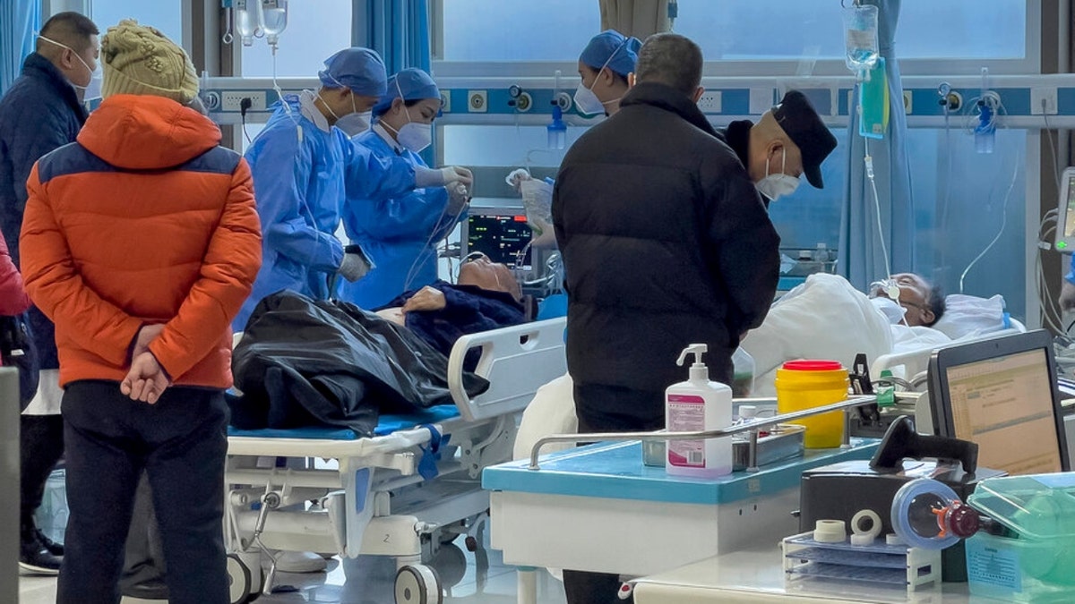 Beijing medical workers check on an elderly patient