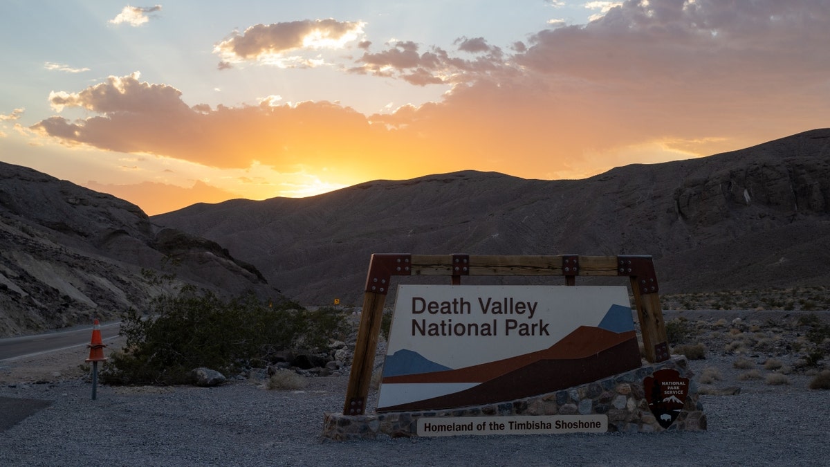A sunset behind the Death Valley National Park welcome sign
