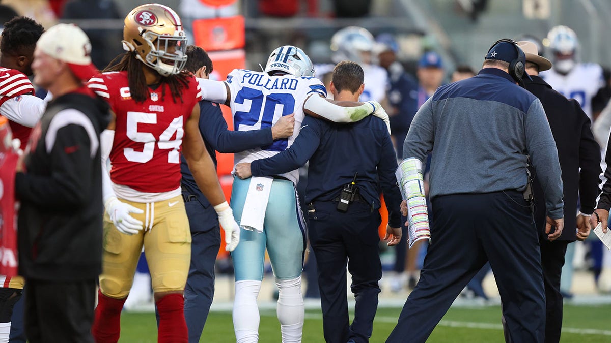 Tony Pollard is assisted by medical staff