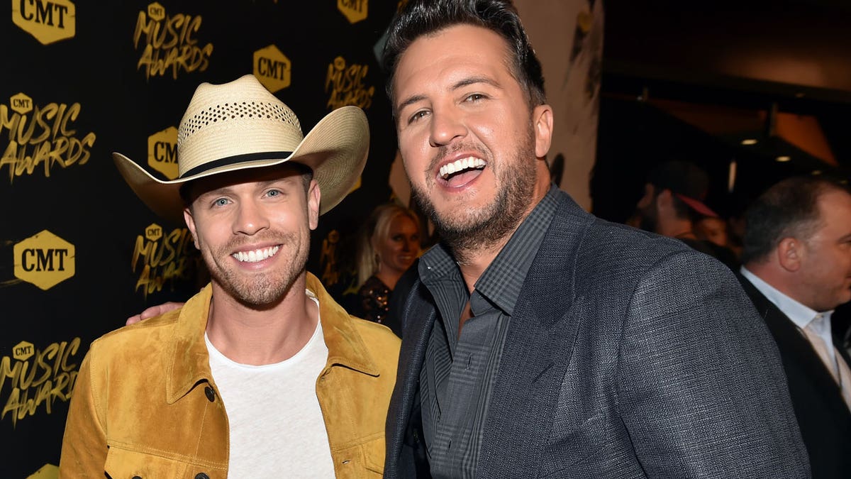 Dustin Lynch and Luke Bryan smiling