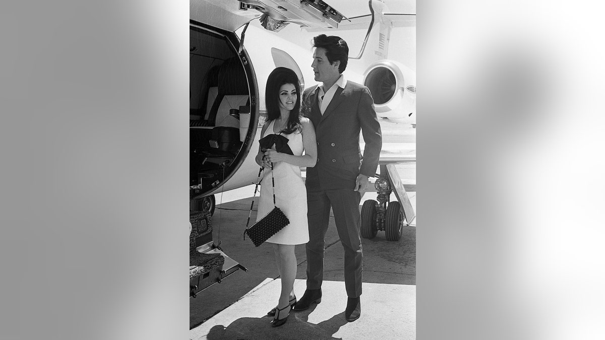 Elvis Presley and Priscilla by an airplane