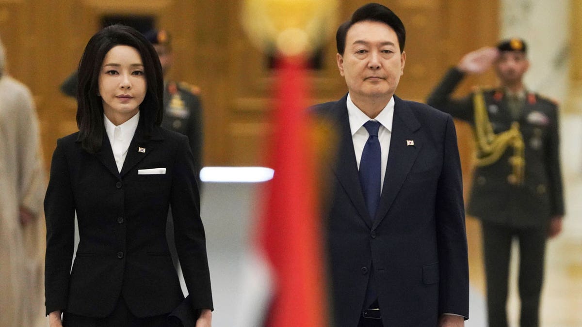 SK President and South Korean first lady standing side by side.