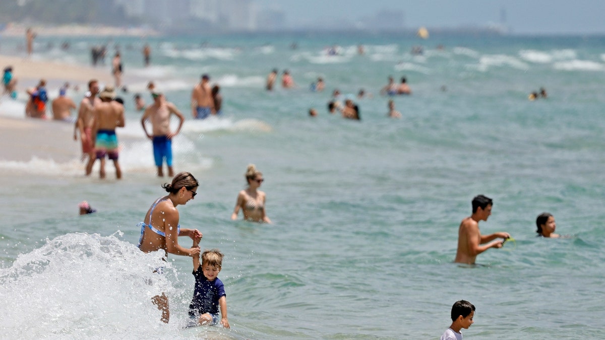 Beachgoers are shown on Fort Lauderdale Beach