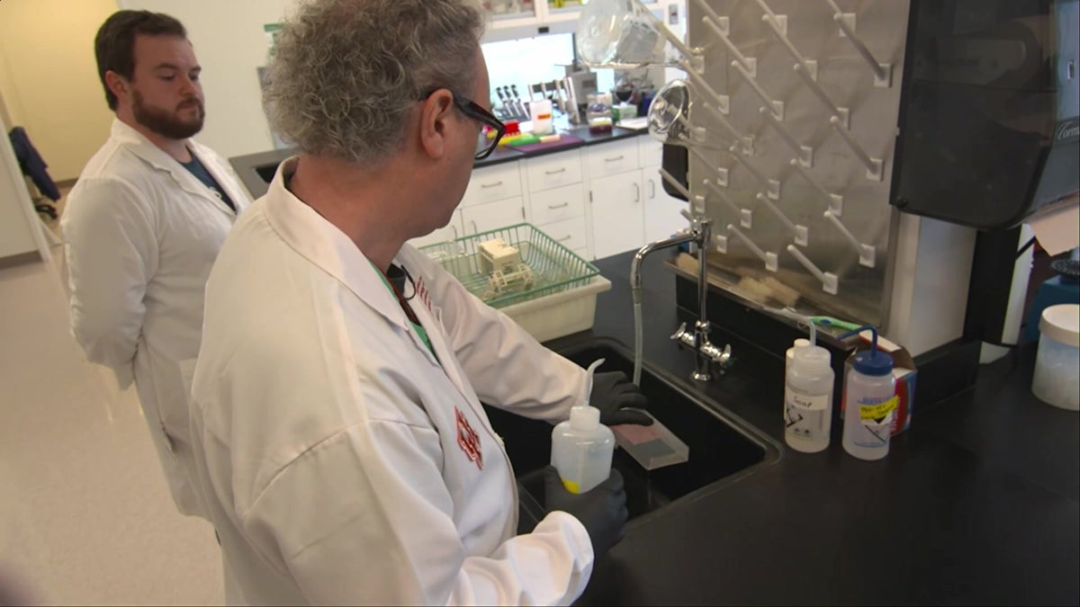 Dr. Colin Haile (center, wearing glasses) is seen here cleaning a sample at his lab at the University of Houston. He believes that the fentanyl vaccine his team has developed can help those in addiction recovery.