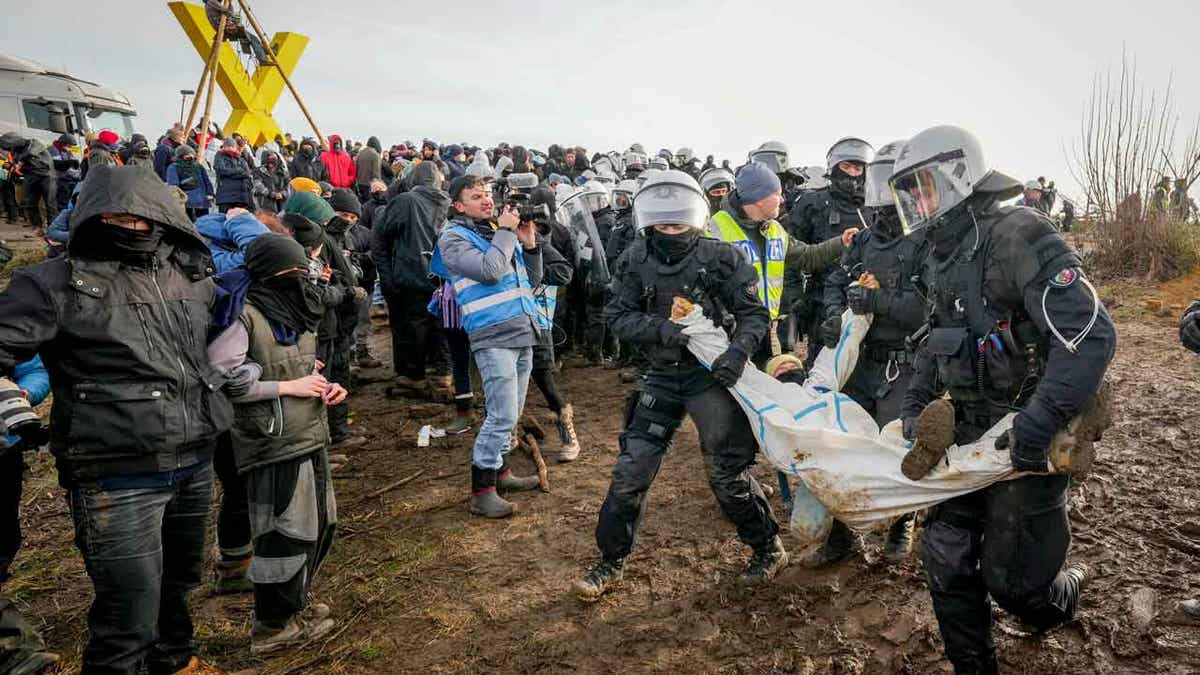 Police carrying German activists