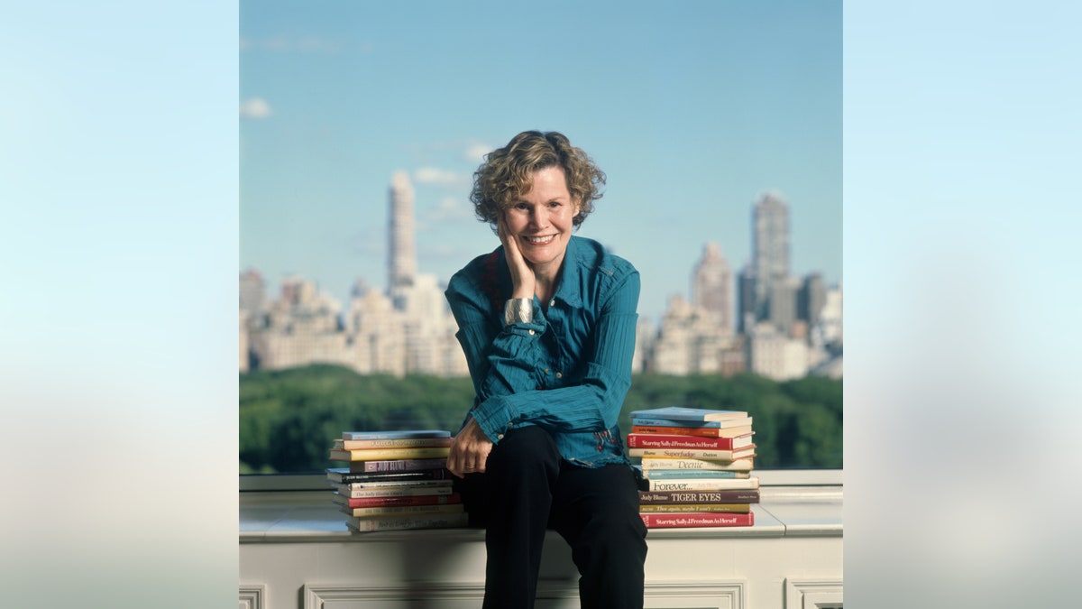 Judy Blume posing with books