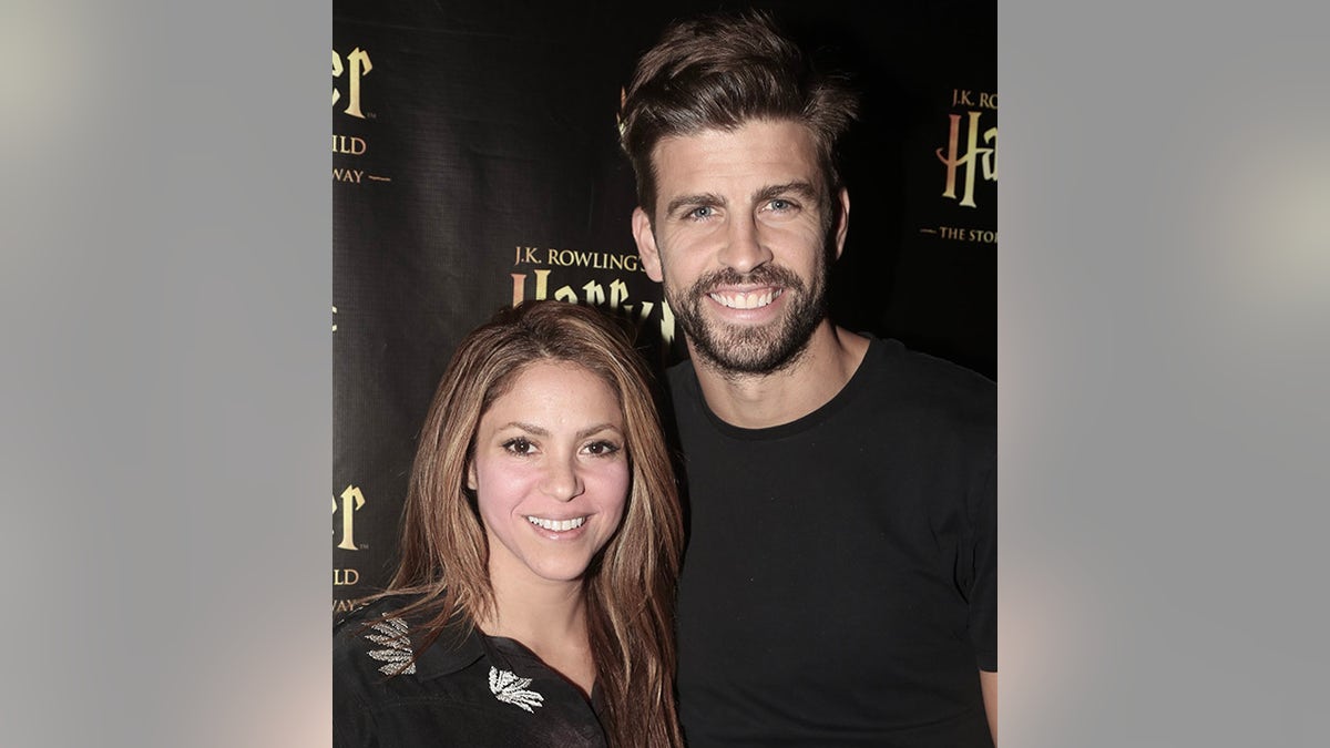Shakira and Gerard Piqué both wearing black pose for a photo backstage at "Harry Potter and the Cursed Child, Parts One & Two" in New York