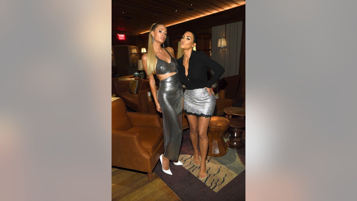Paris Hilton and Kim Kardashian pucker up for the camera