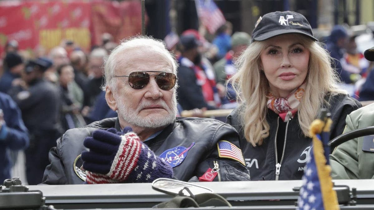 Buzz Aldrin and Anca Faur in car with NASA jackets