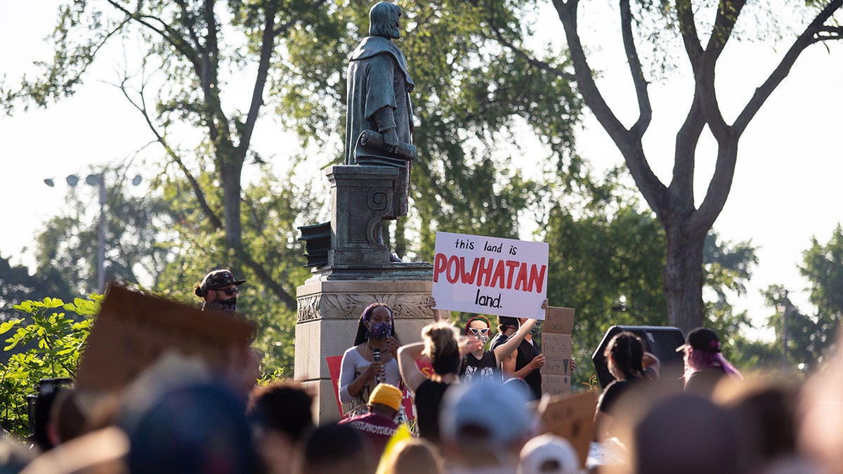 People standing around a statue