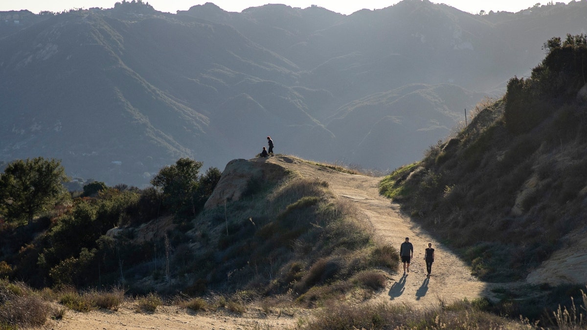 Hikers walk through the Santa Monica Mountains