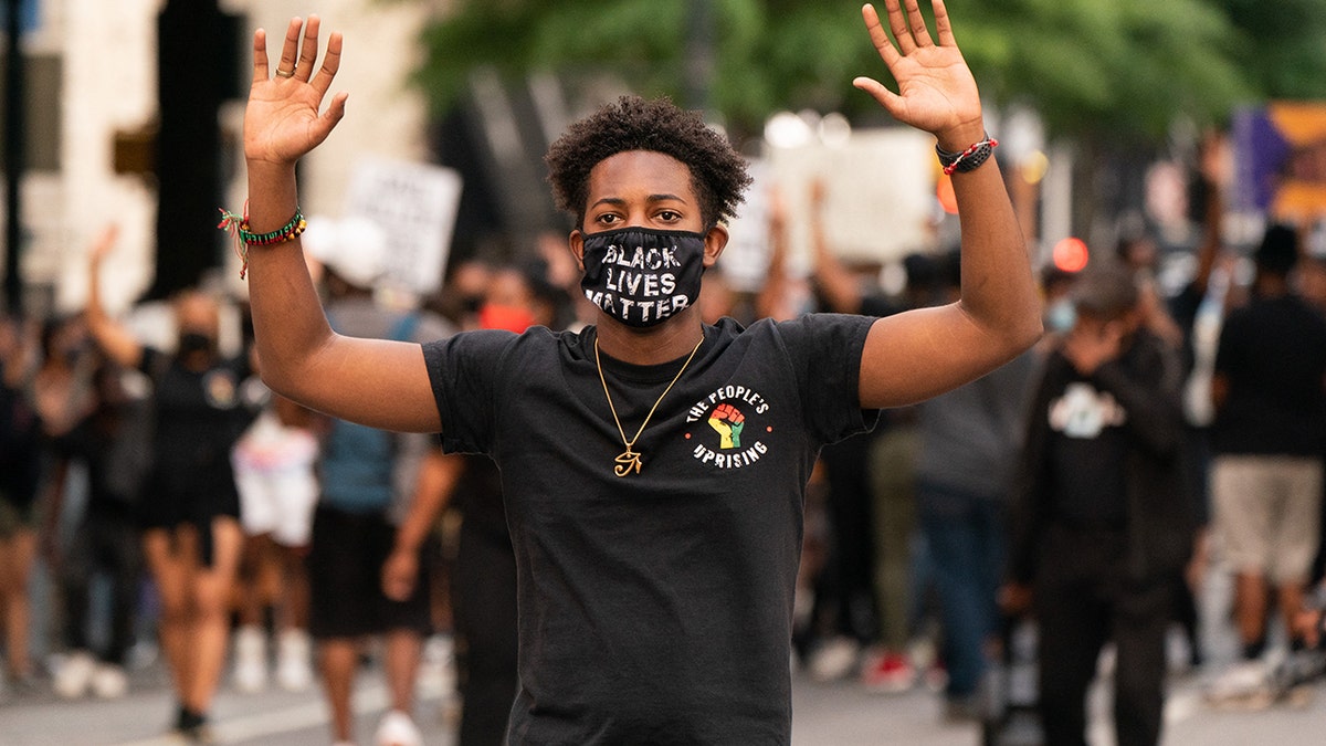 A protester with his hands up