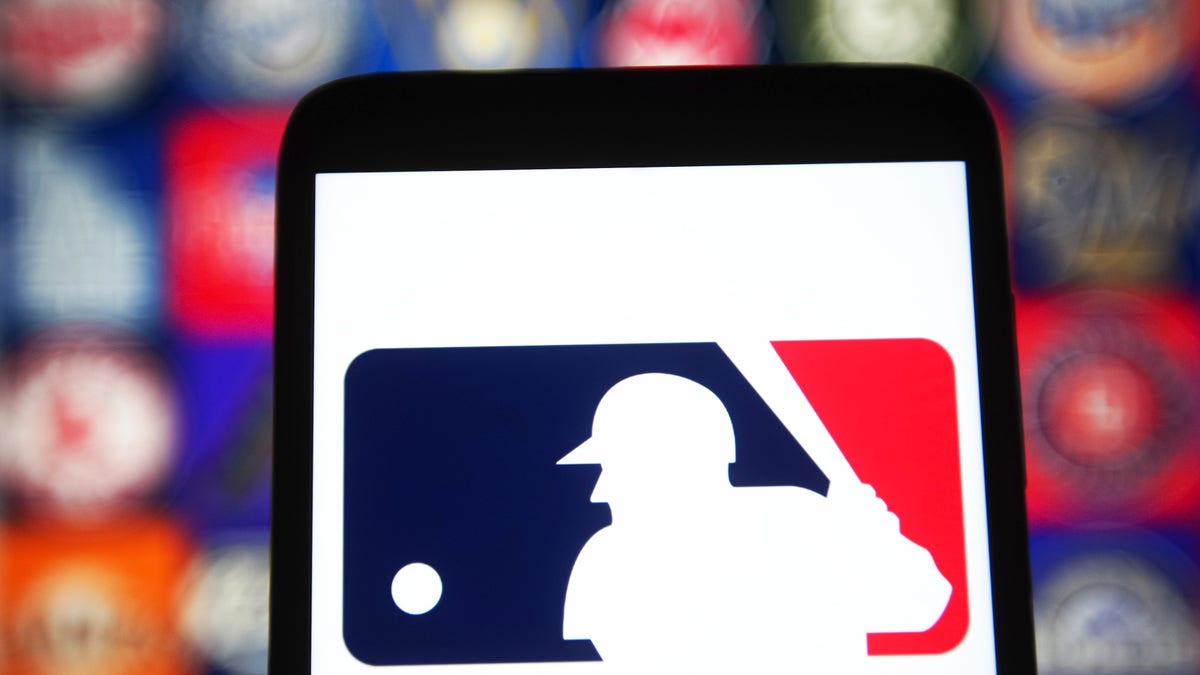 In this photo illustration a Major League Baseball (MLB) logo is seen on a smartphone screen. 
