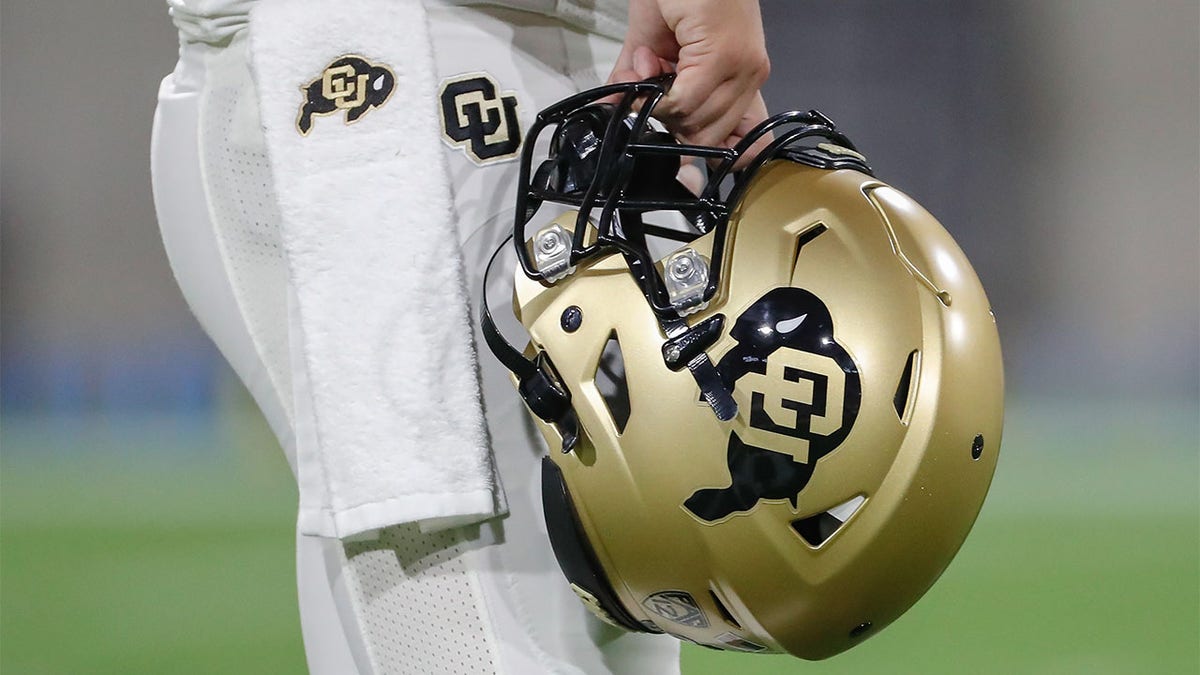 A player holds a Colorado Buffaloes helmet in 2021