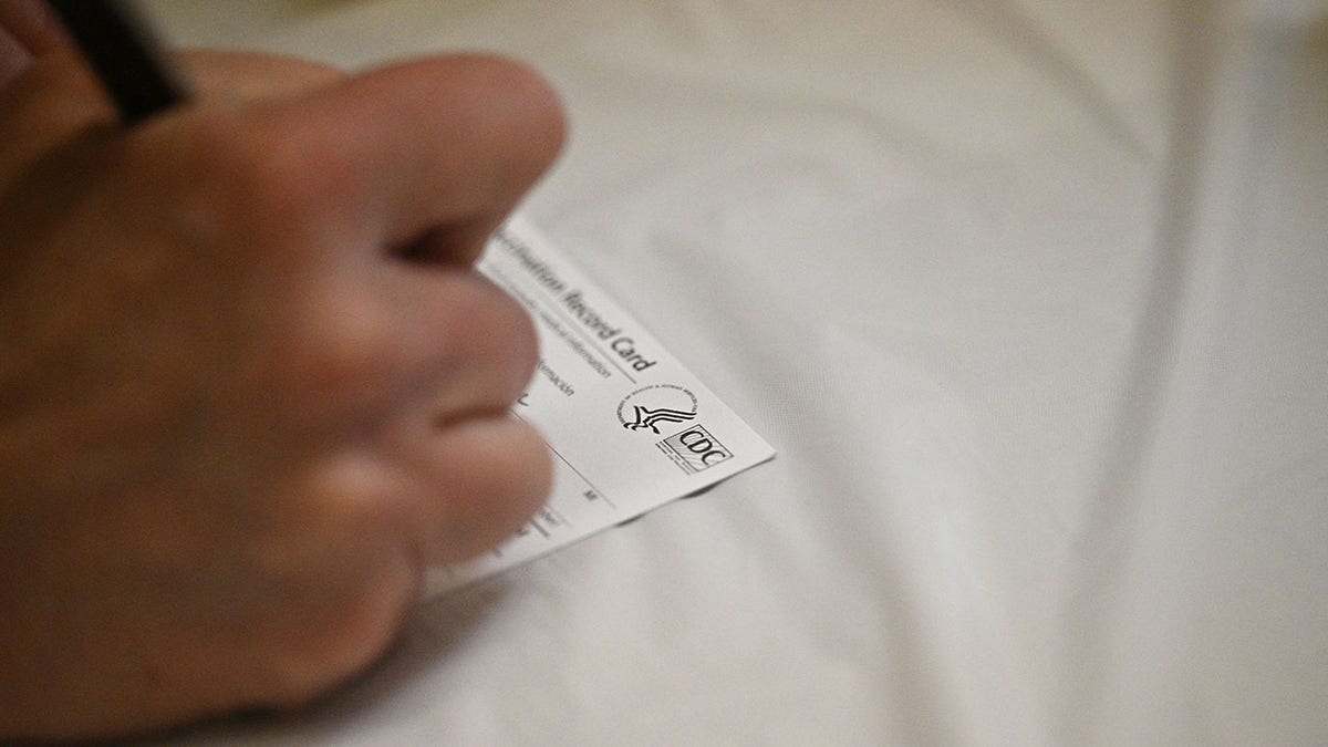 nurse fills out CDC card