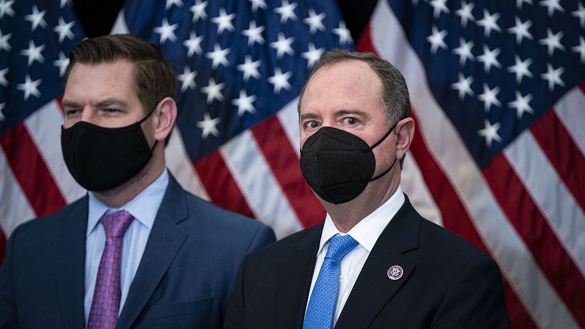 Eric Swalwell and Adam Schiff wearing black masks