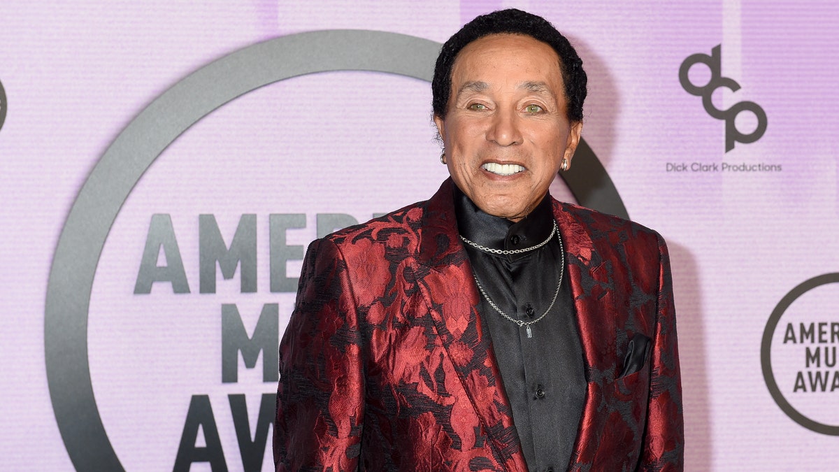 Motown legend Smokey Robinson smiling on the carpet at the American Music Awards in 2022
