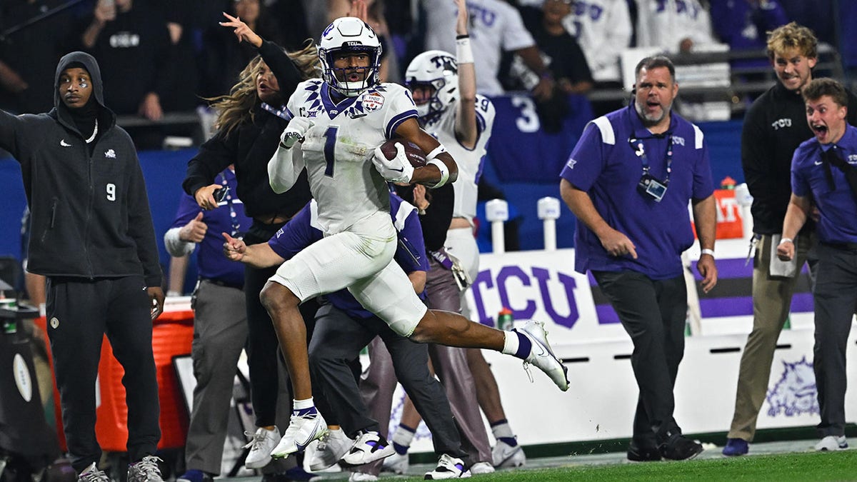 Quentin Johnston rushes for a touchdown against Michigan