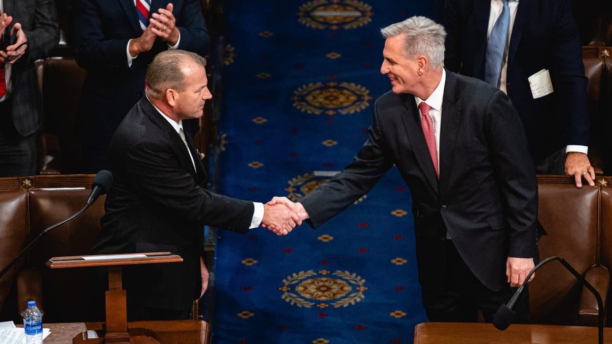 Representative Kevin McCarthy, a Republican from California, right, shakes hands with Representative Troy Nehls, a Republican from Texas, while nominating McCarthy to be the next Speaker of the House during a meeting of the 118th Congress in the House Chamber at the US Capitol in Washington, DC, US, on Thursday, Jan. 5, 2023.