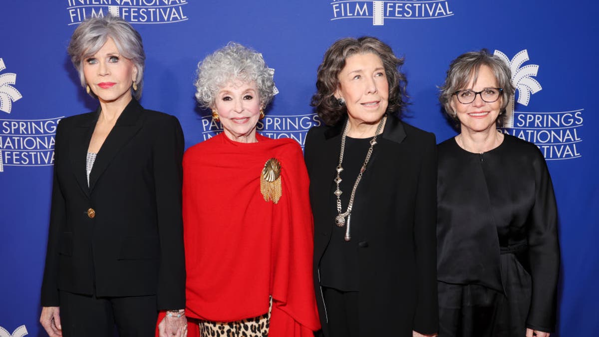 Jane Fonda in black, Rita Moreno in a red top and cheetah bottom, Lily Tomlin and Sally Field in black all on the red carpet for "80 for Brady"