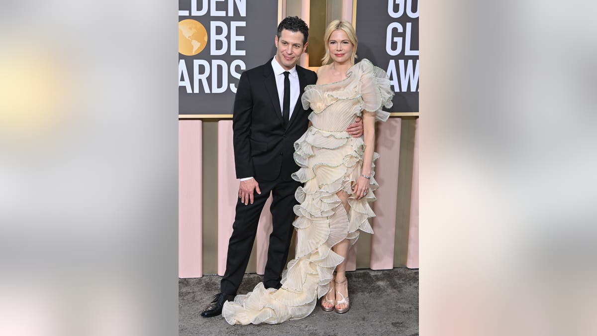 Michelle Williams and husband Thomas Kail attend the 2023 Golden Globes