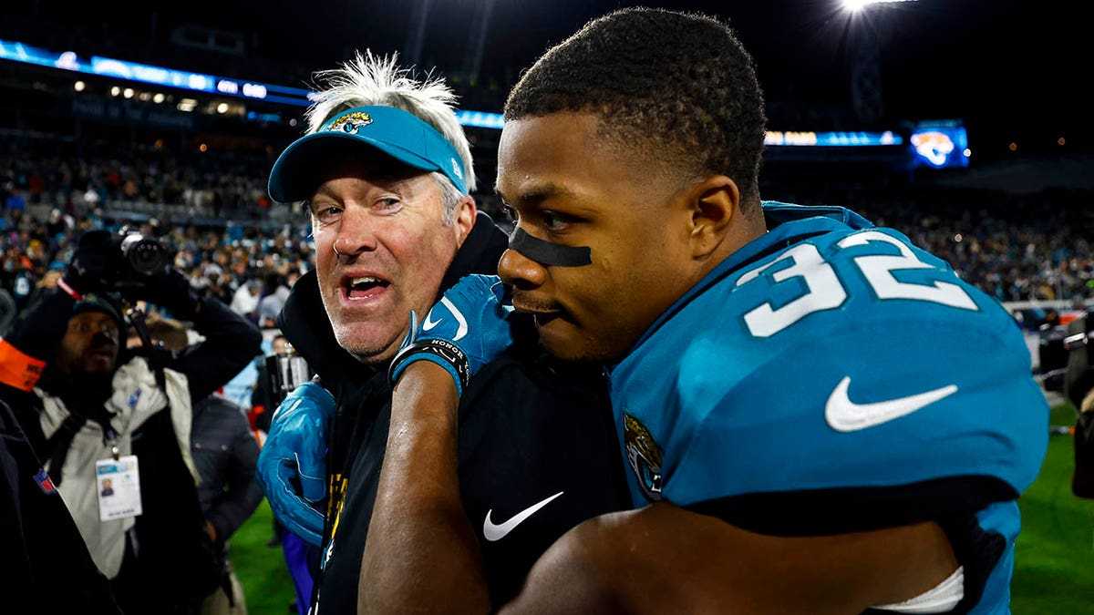 Tyson Campbell embraces Doug Pederson after a wild card victory