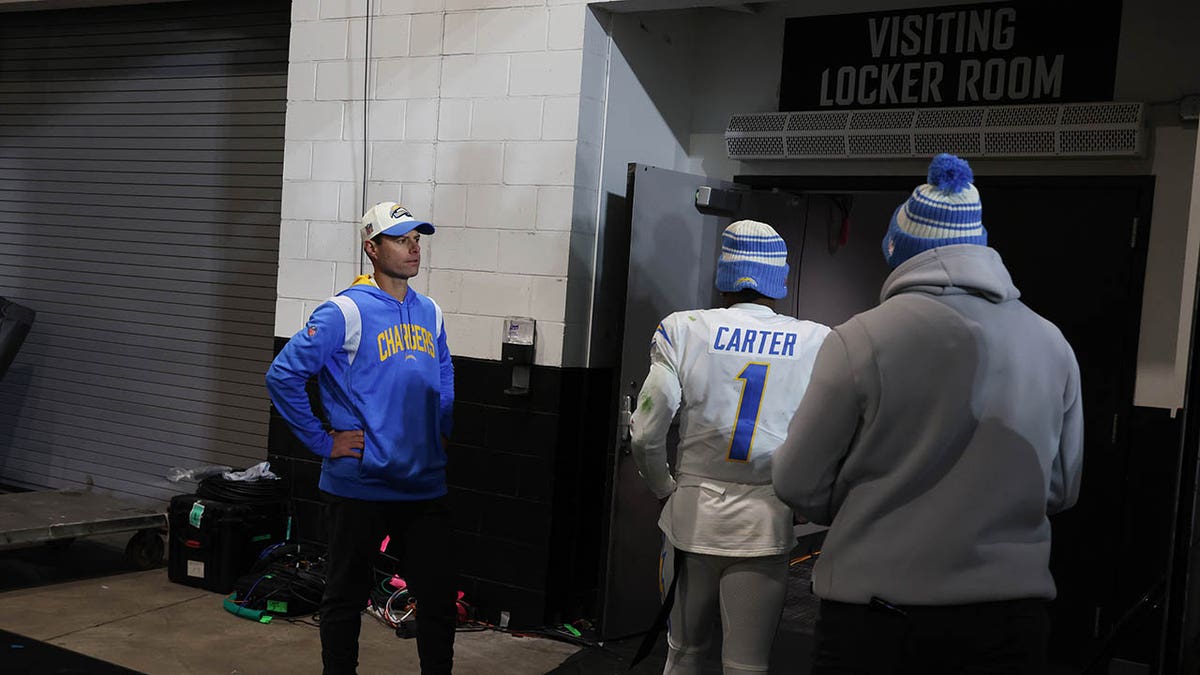 Brandon Staley stands as players enter the locker room following a loss to the Jaguars