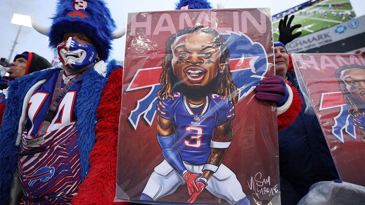 Football: Buffalo Bills fan holds a poster of Damar Hamlin (3) vs. New England Patriots at Highmark Stadium. Buffalo, NY 1/8/2023