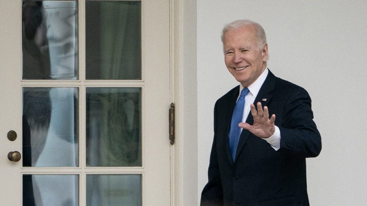 President Joe Biden walks to the Oval Office